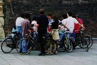 [Bicyclists
hanging out in the Piazza Maggiore (photo)]